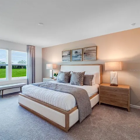 a bedroom with a bed and lamp