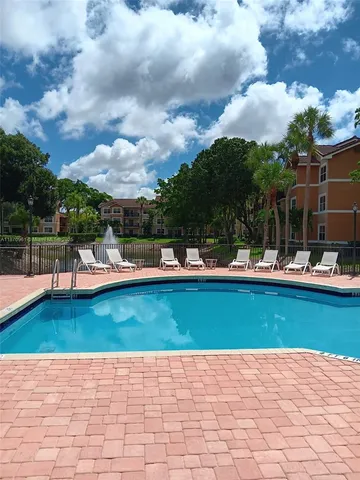 a view of swimming pool with outdoor seating and plants