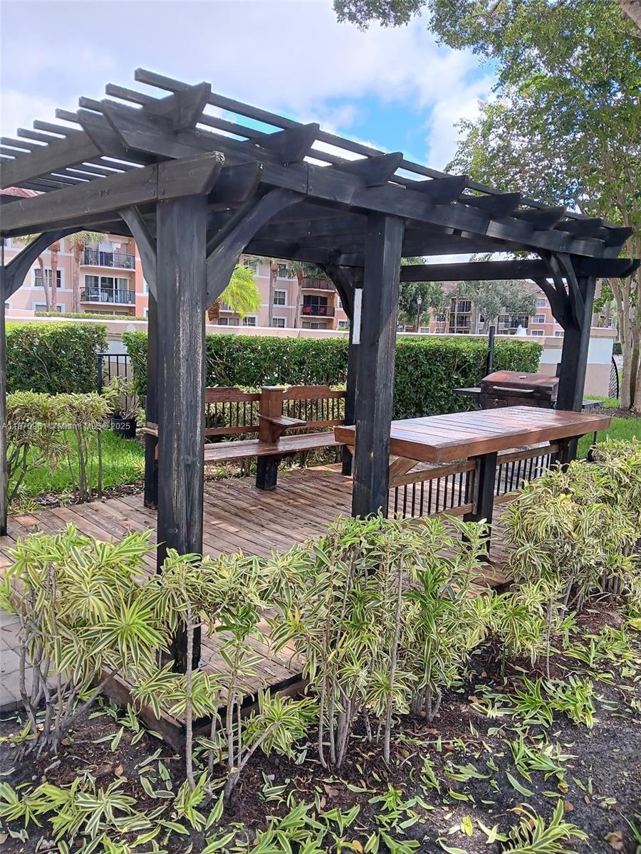 8821 Wiles Road, Unit 308 Coral Springs, FL 33067 - Photo 17 of 18 a view of a porch with a bench in patio