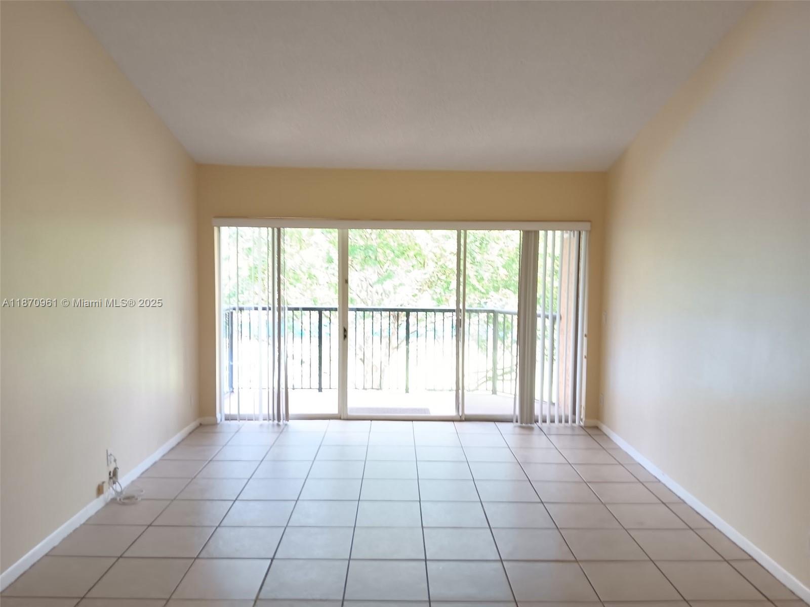 8821 Wiles Road, Unit 308 Coral Springs, FL 33067 - Photo 3 of 18 a view of an empty room and window
