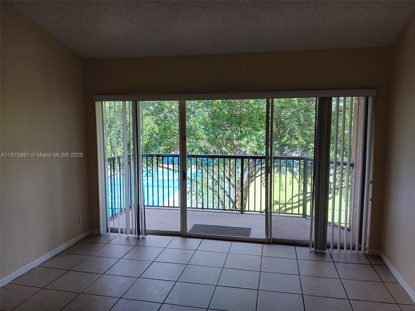 8821 Wiles Road, Unit 308 Coral Springs, FL 33067 - Photo 4 of 18 a view of a room that has a large window