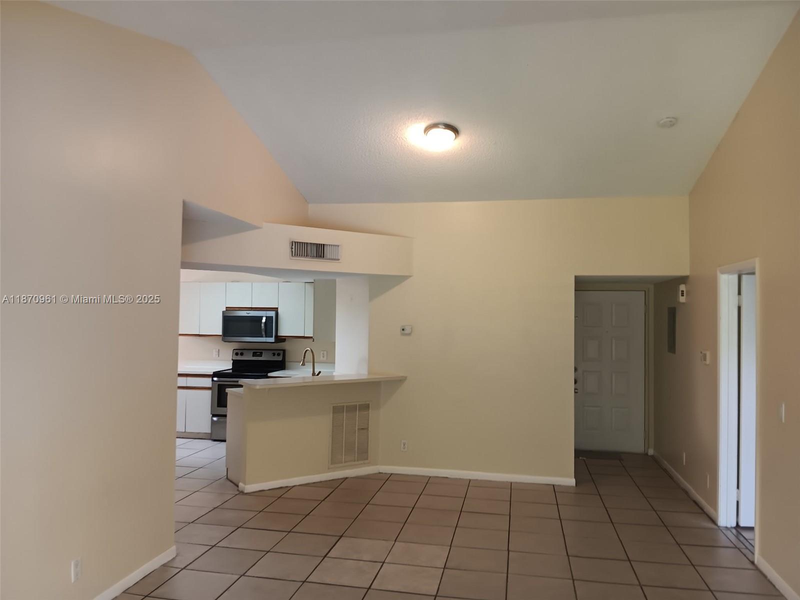 8821 Wiles Road, Unit 308 Coral Springs, FL 33067 - Photo 6 of 18 a kitchen with a sink a stove and cabinets