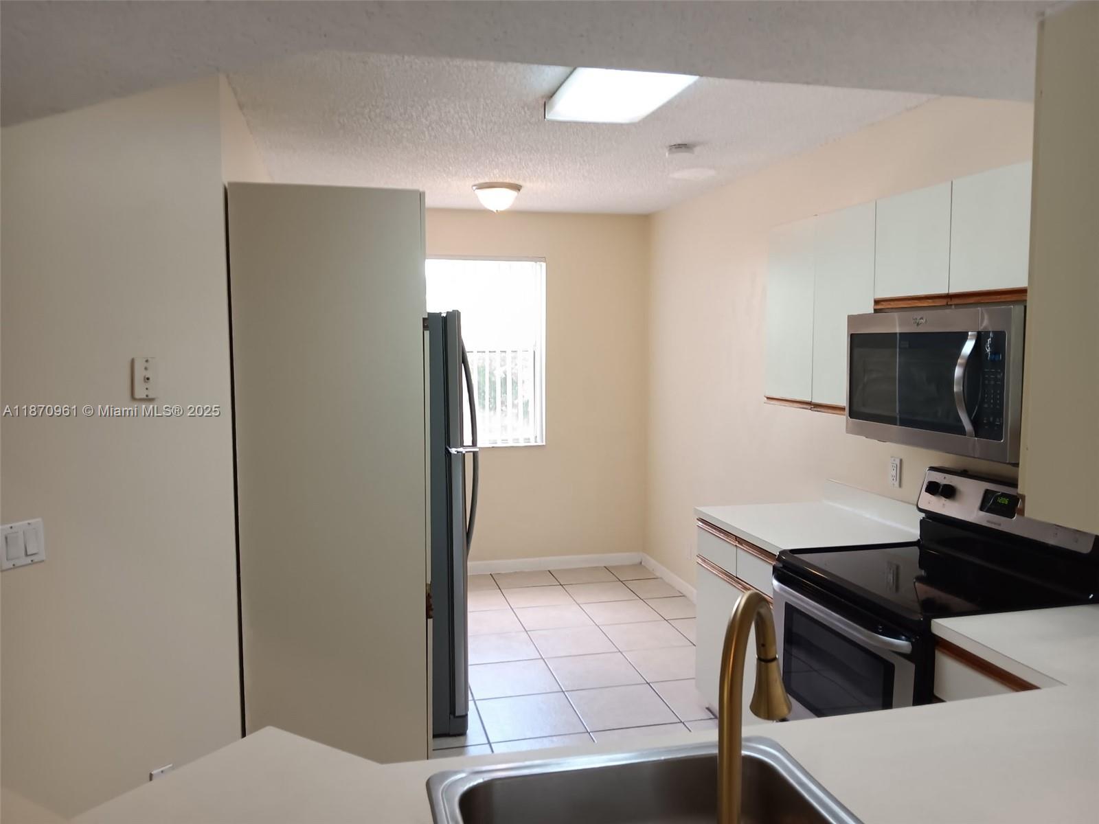 8821 Wiles Road, Unit 308 Coral Springs, FL 33067 - Photo 7 of 18 a living room with a flat screen tv and a toilet