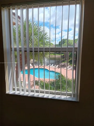 a view of a porch with a floor to ceiling window