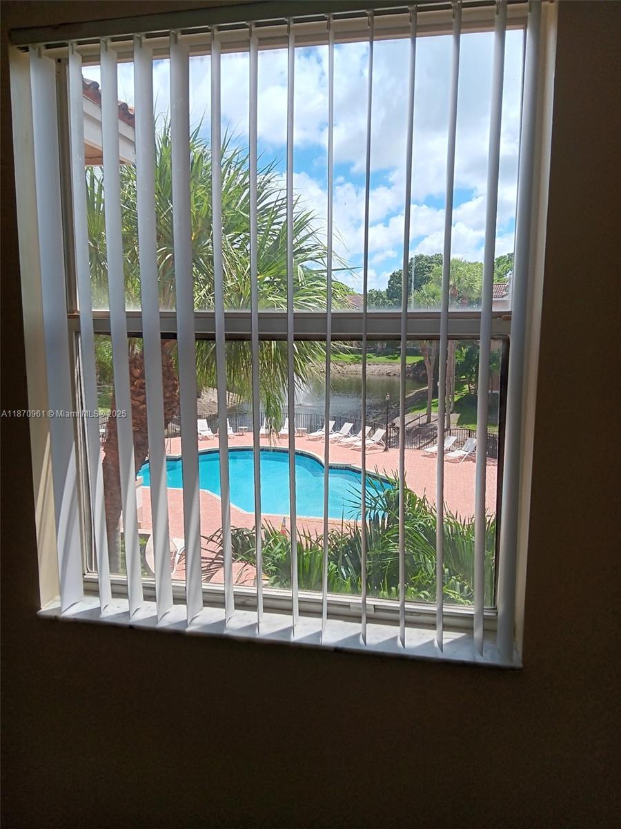 8821 Wiles Road, Unit 308 Coral Springs, FL 33067 - Photo 9 of 18 a view of a porch with a floor to ceiling window