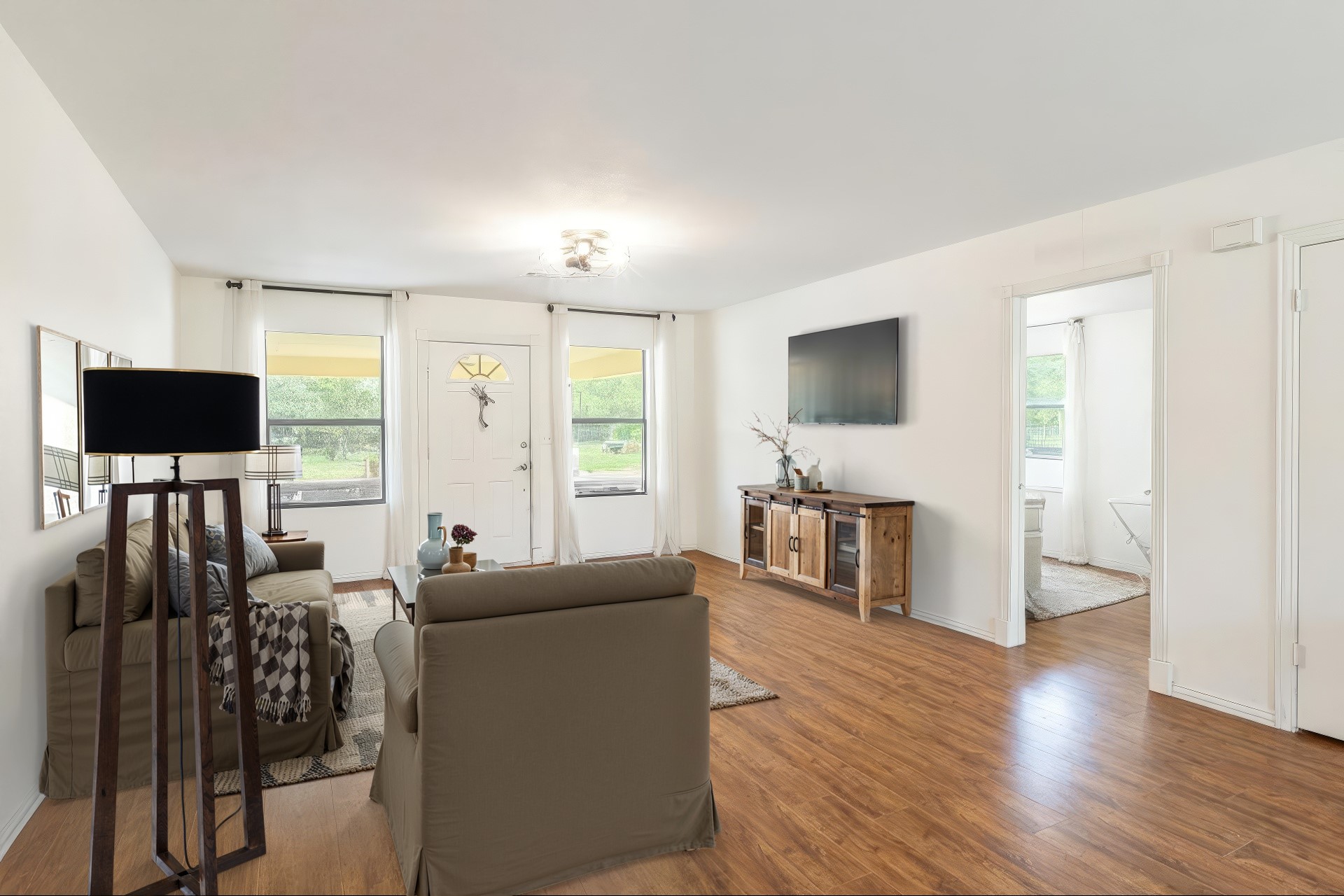 326 Zapalac Road Smithville, TX 78957 - Photo 2 of 8 a living room with furniture a flat screen tv and wooden floor