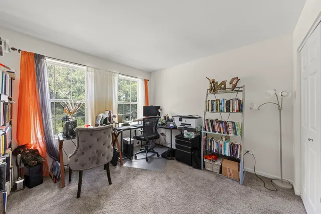 a view of a livingroom with furniture and a window