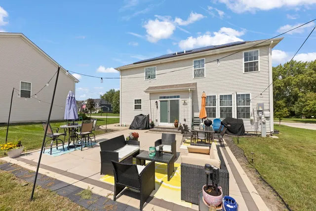a view of a house with backyard sitting area and garden