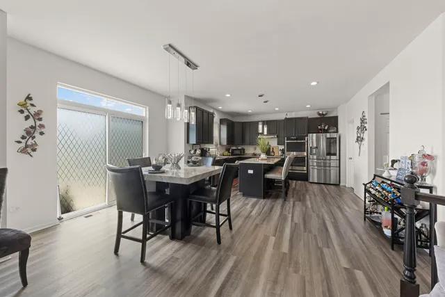 a view of a dining room with furniture and wooden floor