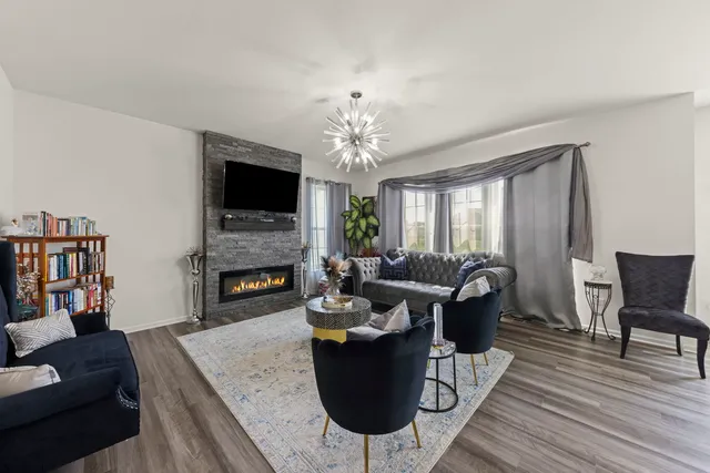 a living room with furniture a fireplace and a flat screen tv
