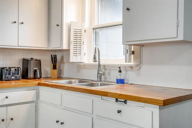 a kitchen with stainless steel appliances granite countertop a sink and a cabinets