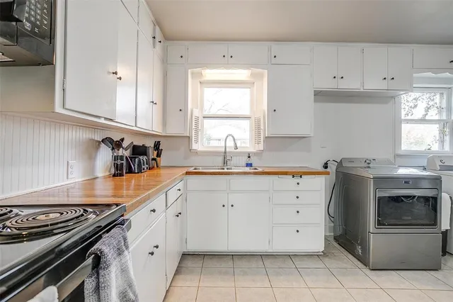 a kitchen with cabinets appliances and a window