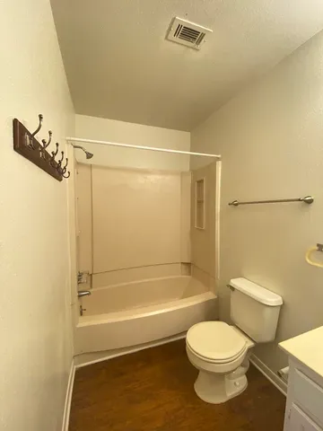 a bathroom with a toilet and shower