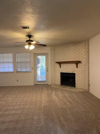 a view of an empty room with a fireplace