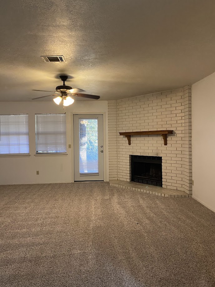 1305 West Villa Maria Road, Unit C103 Bryan, TX 77801 - Photo 5 of 19 a view of an empty room with a fireplace
