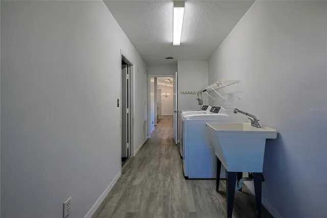 a view of a room that has a couch and wooden floor