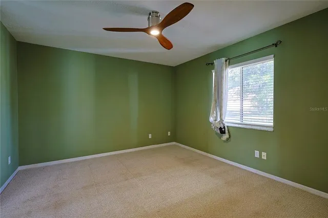 a view of room with window and ceiling fan