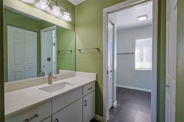a bathroom with a sink a mirror and a shower