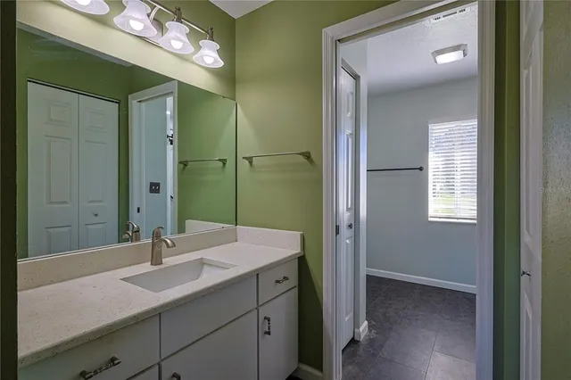 a bathroom with a sink a mirror and a shower