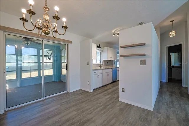 a view of a room with wooden floor chandelier