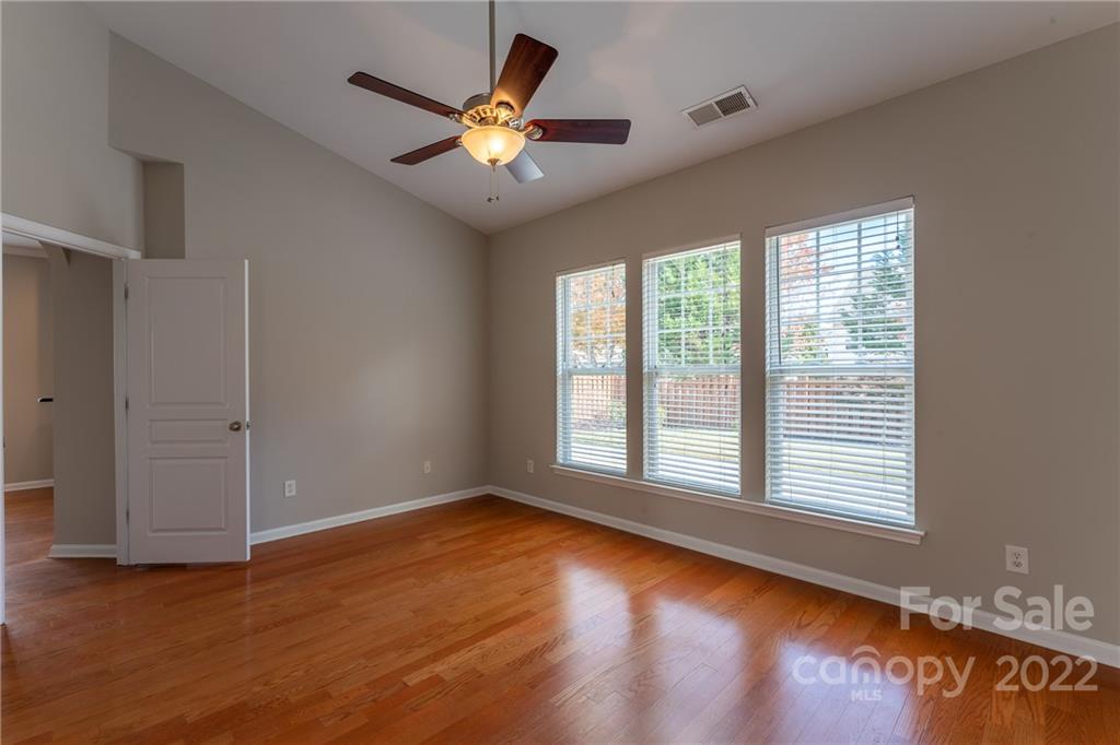 261 Sand Paver Way Fort Mill, SC 29708 - Photo 14 of 45 a view of an empty room with wooden floor and a window