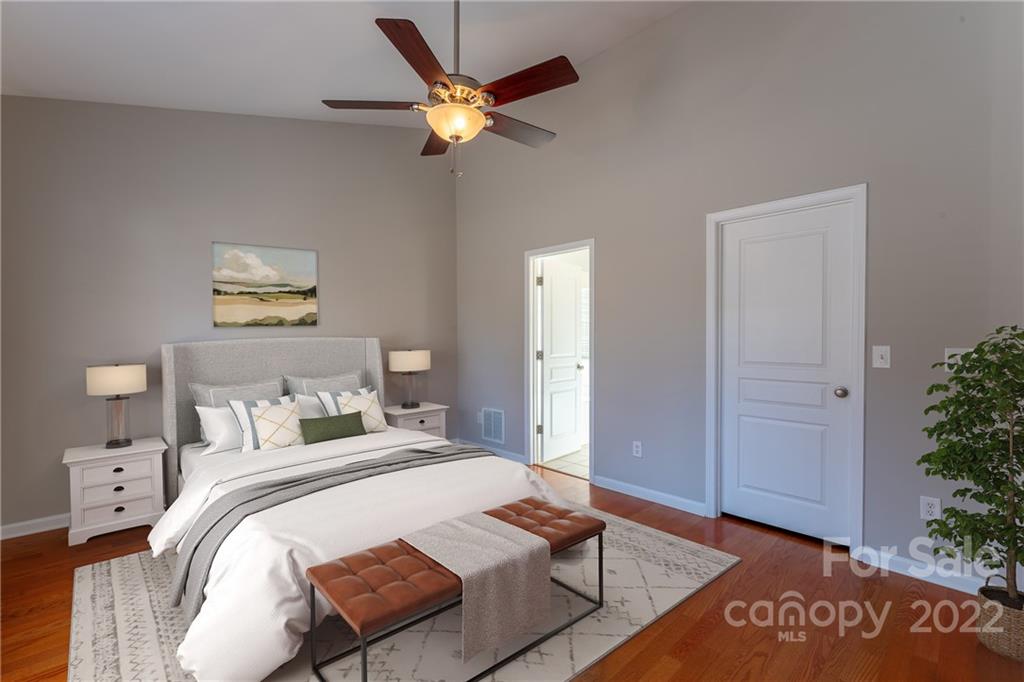 261 Sand Paver Way Fort Mill, SC 29708 - Photo 16 of 45 a bedroom with a bed and a chandelier