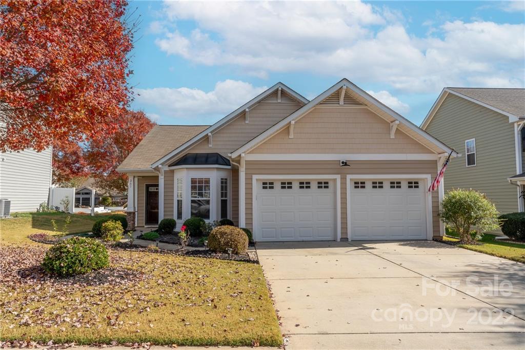 261 Sand Paver Way Fort Mill, SC 29708 - Photo 2 of 45 a front view of a house with a yard and garage