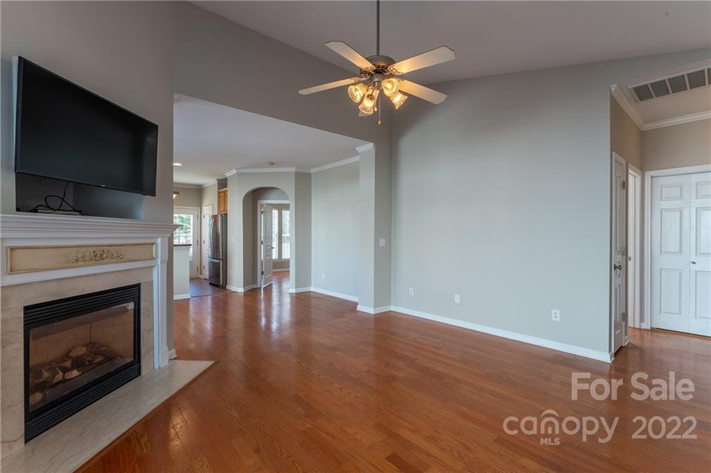 261 Sand Paver Way Fort Mill, SC 29708 - Photo 5 of 45 a view of an empty room with wooden floor fireplace and a window