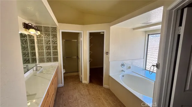 a bathroom with a tub sink and shower