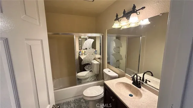 a bathroom with a sink a toilet a mirror and vanity