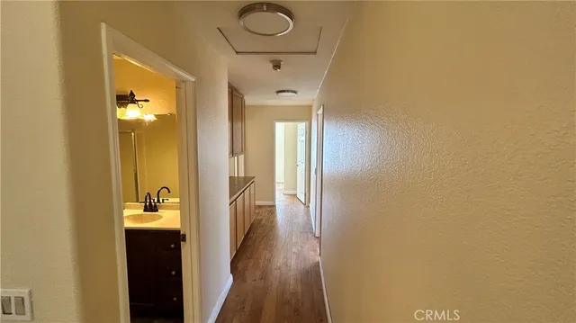 a view of a hallway with wooden floor