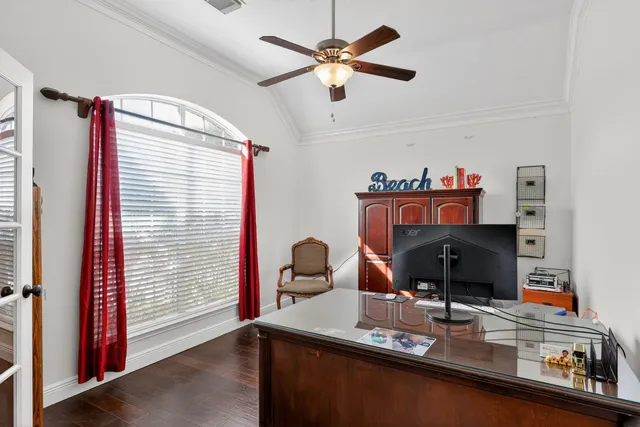 a view of a workspace with furniture and a window