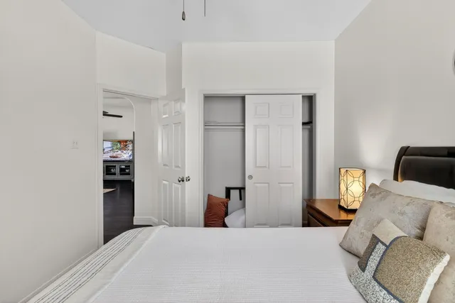 a bedroom with a bed and cabinets