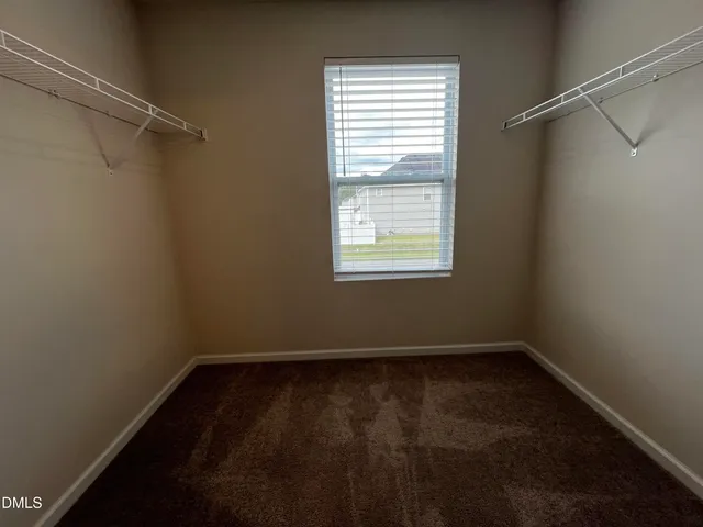 a view of a room with window and a fan