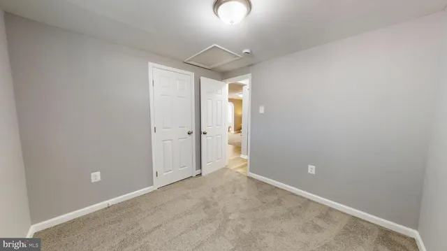 an empty room with a ceiling fan