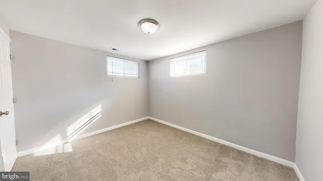 an empty room with a empty space and a window