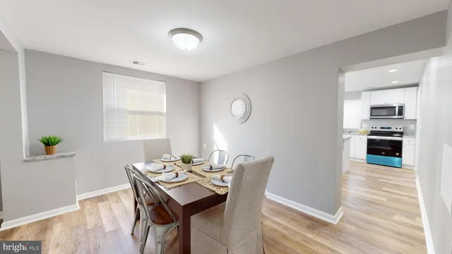 a view of a dining room with furniture and a window