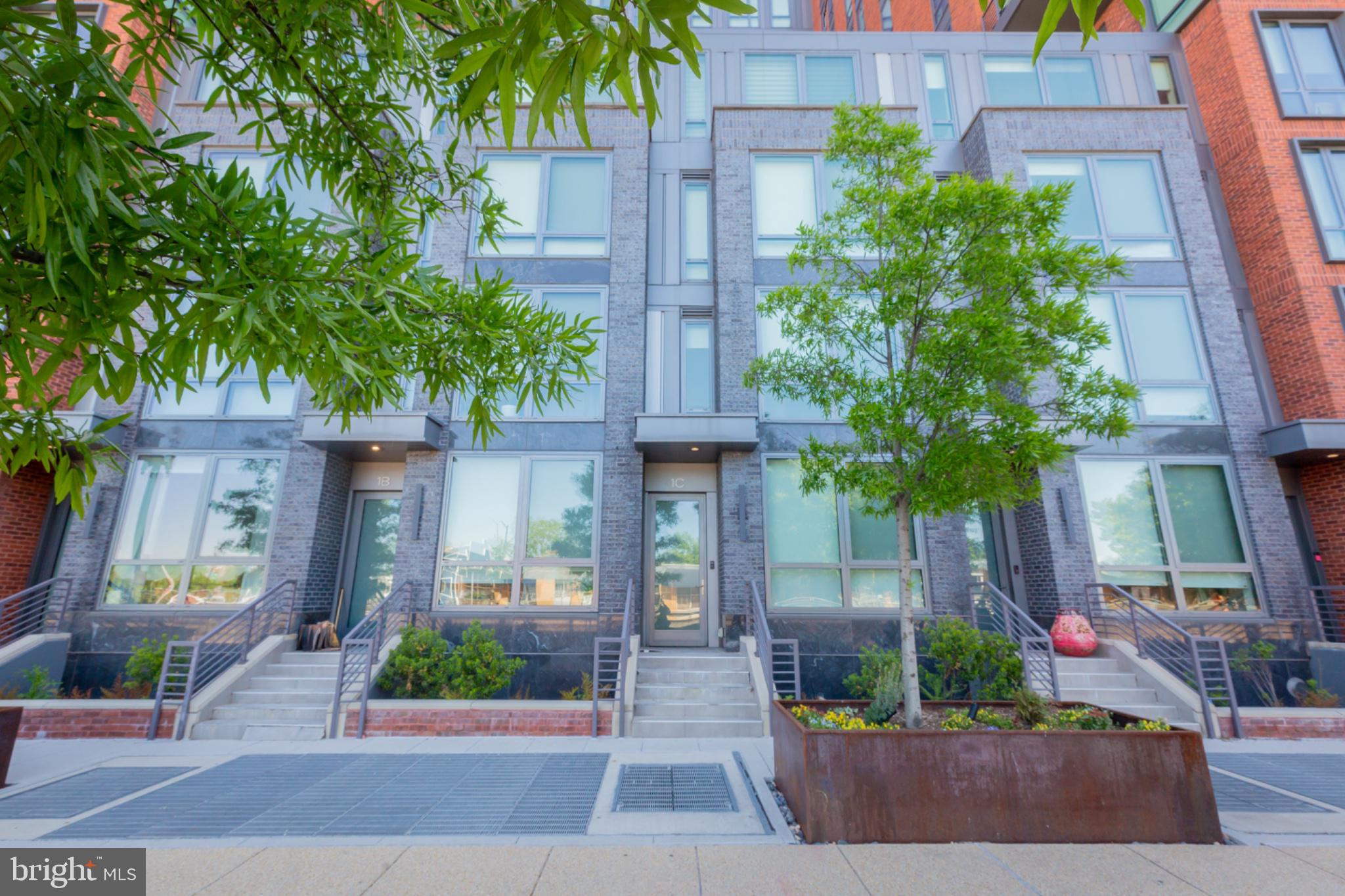 1211 Van Street Southeast, Unit TH1C Washington, DC 20003 - Photo 29 of 31 Modern townhomes with lush greenery.