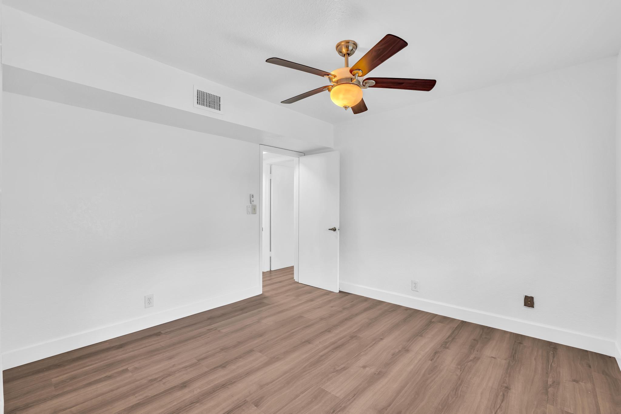 1291 Northwest 13th Street, Unit 445D Boca Raton, FL 33486 - Photo 42 of 50 a view of a room with wooden floor and window