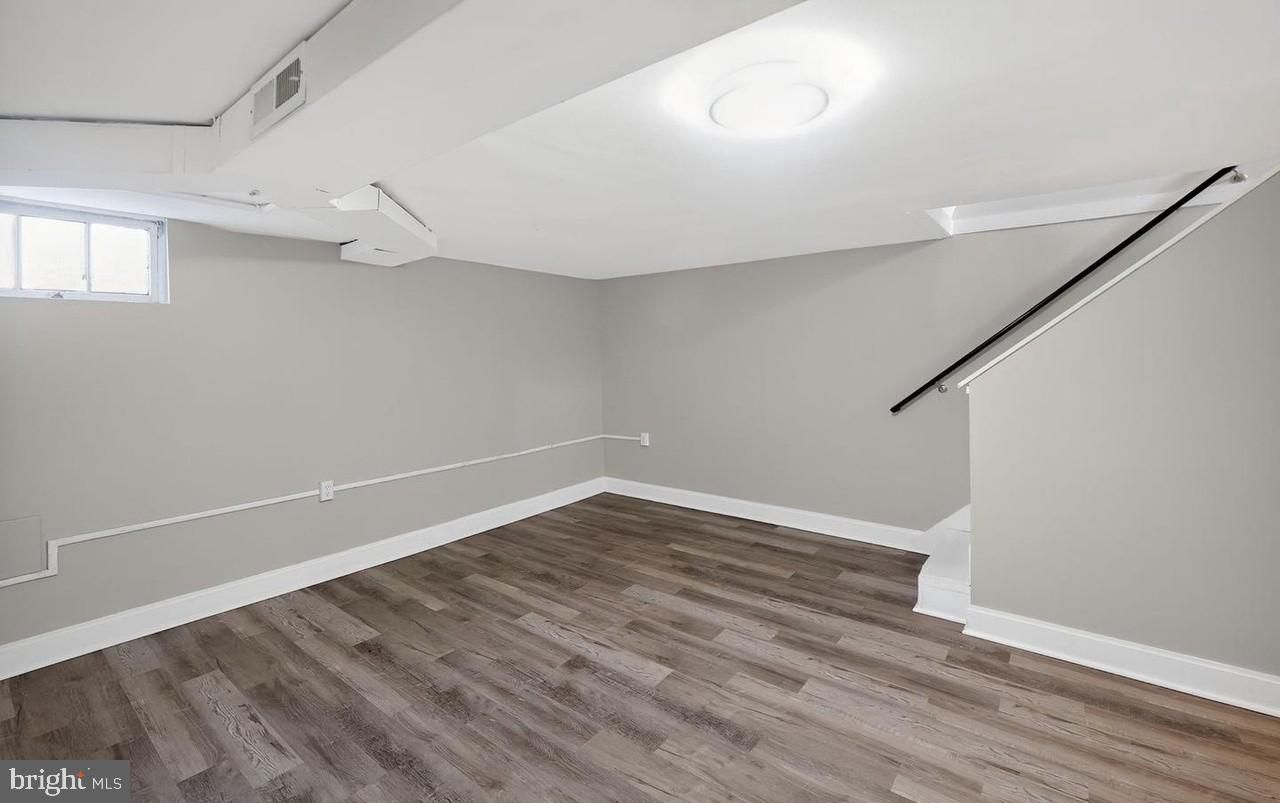 60 South Hawthorne Road Middle River, MD 21220 - Photo 5 of 18 a view of an empty room with wooden floor and a window
