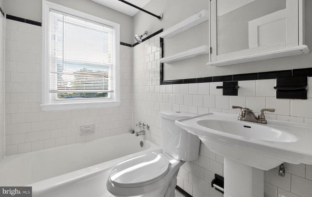 60 South Hawthorne Road Middle River, MD 21220 - Photo 6 of 18 a bathroom with a sink a toilet and bathtub