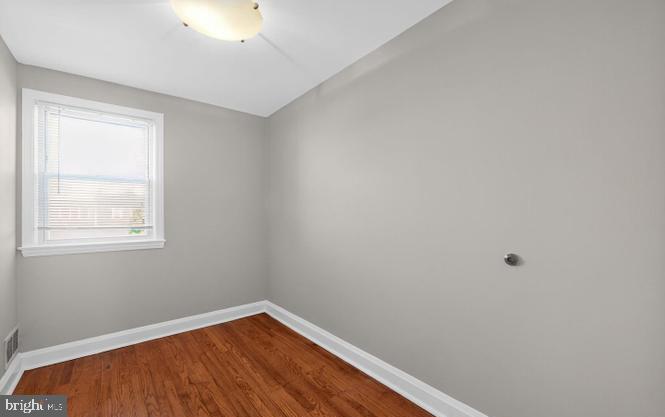60 South Hawthorne Road Middle River, MD 21220 - Photo 8 of 18 a view of an empty room with wooden floor and a window