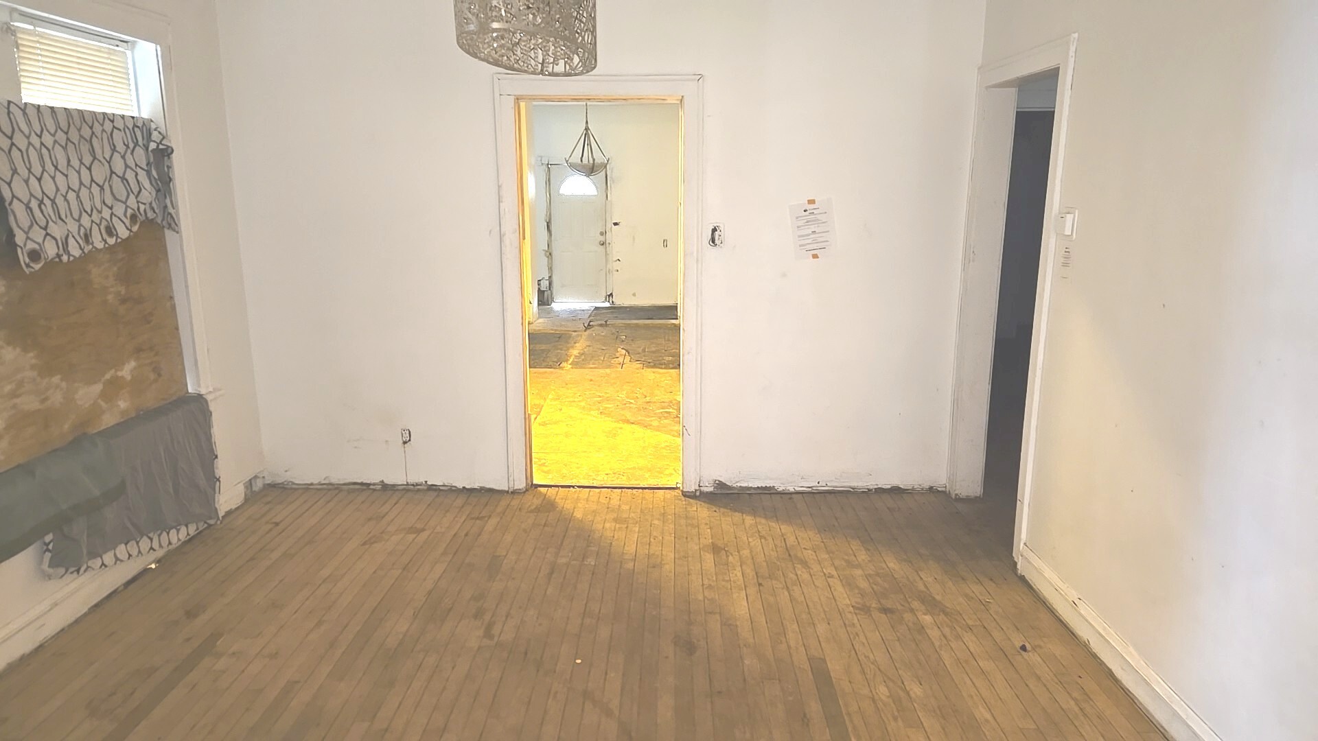 8216 South Rhodes Avenue Chicago, IL 60619 - Photo 9 of 22 an empty room with a door and wooden floor