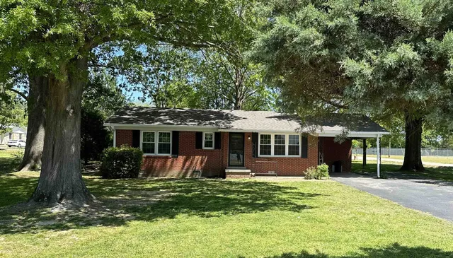 a front view of house with yard and green space