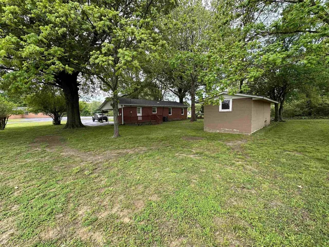 a view of a tree in front of a house
