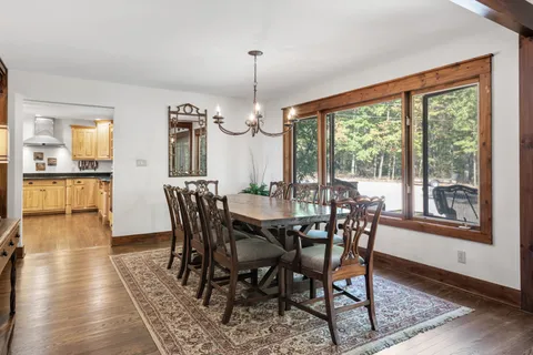 a dining table with chairs and wooden floor