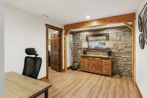 a view of a dining room with a table and chairs