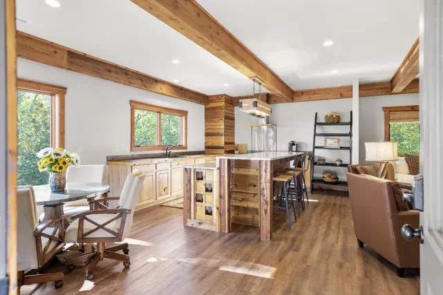 a living room with furniture a rug and a window