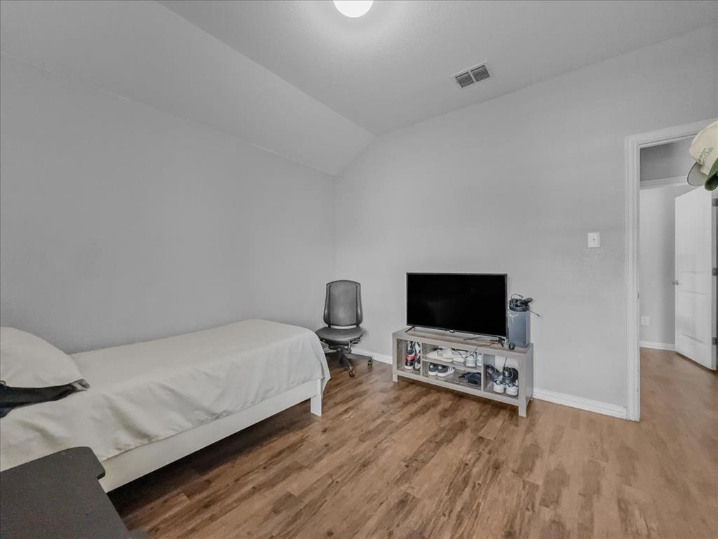 14201 Bridgeview Lane Dallas, TX 75253 - Photo 11 of 26 a room with furniture and a flat screen tv