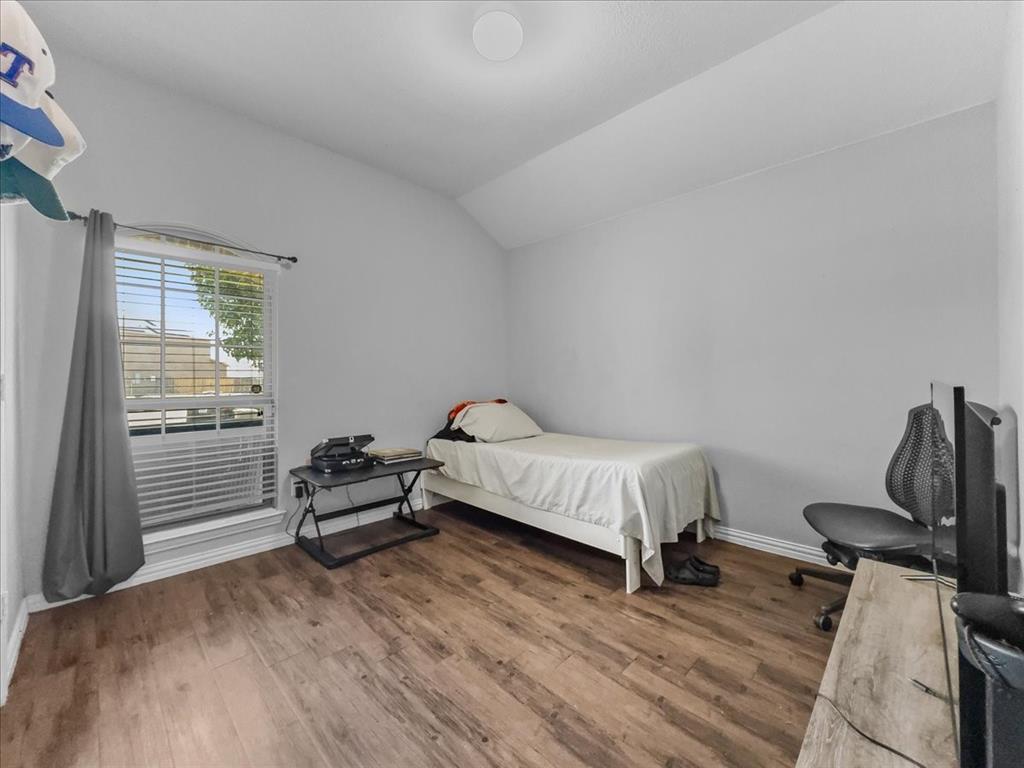 14201 Bridgeview Lane Dallas, TX 75253 - Photo 14 of 26 a bedroom with a bed and a window